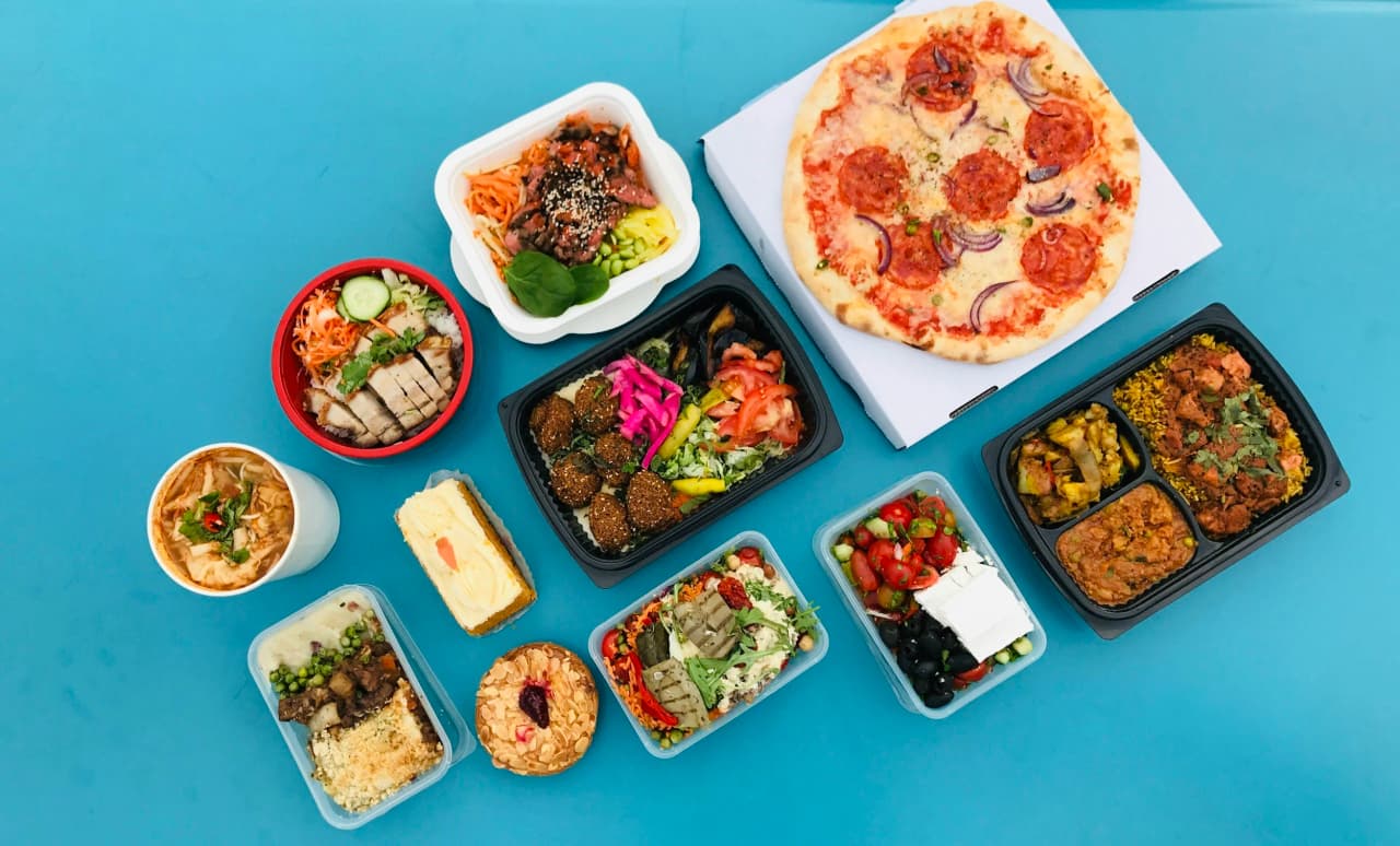 Assorted prepared meals packed in delivery containers